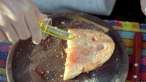 Image of a hand cooking a plate of bread with tomato garlic oil salt and Stock Footage 158723437