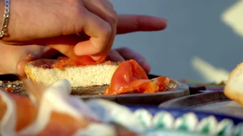 Image of a hand cooking a plate of bread with tomato garlic oil salt and Stock Footage 158723897