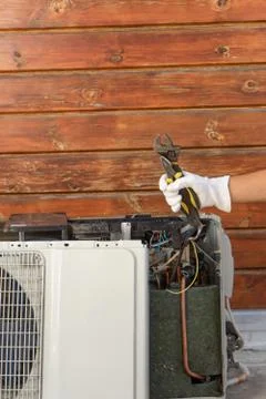 Image of a hand holding a set of tools for repair and maintenance of air cond Stock Photos