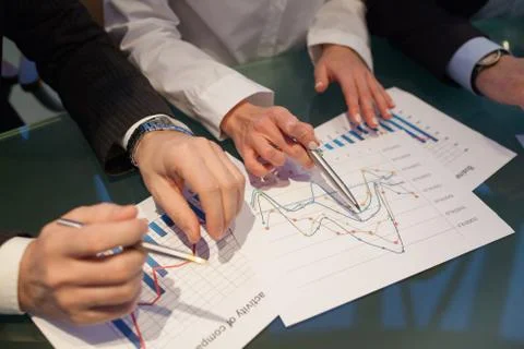 Image of hands pointing at business document during discussion at meeting. Stock-Fotos