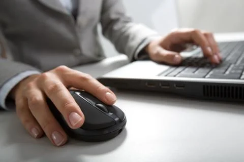 Image of hands pushing keys of a computer mouse and keyboard Stock Photos