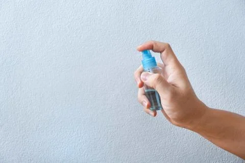 Image of hands using alcohol in bottle spraying hand washing cleaning anti vi Stock Photos