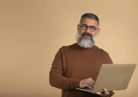 Image of handsome bearded man on light isolated wall background looking at ca Stock Photos