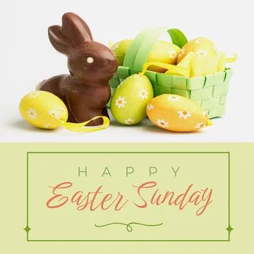 Image of happy easter sunday text over chocolate rabbit and easter eggs 写真素材