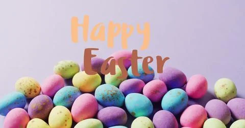 Image of happy easter text over colourful easter eggs on purple background Stock Photos