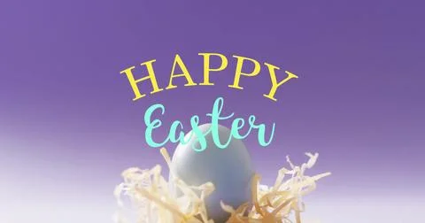 Image of happy easter text over blue easter egg in hey on purple background Stock Photos