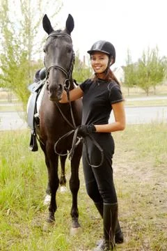 Image of happy female jockey with purebred horse outdoors Stock Photos