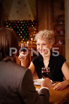 Image of happy female toasting in restaurant while looking at her sweetheart Stock Photos