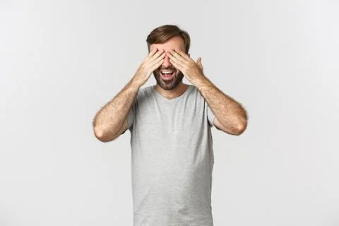Image of happy smiling guy with beard, close eyes and waiting for surprise 스톡 사진
