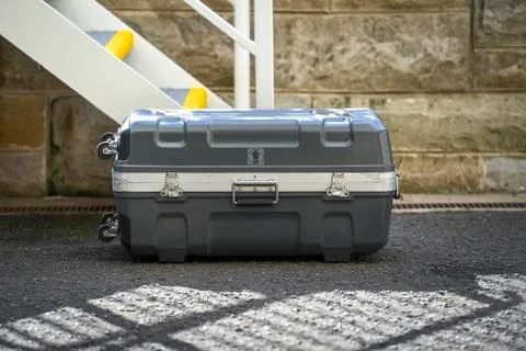 Image of a hard case suitcase on the concrete path Stock Photos