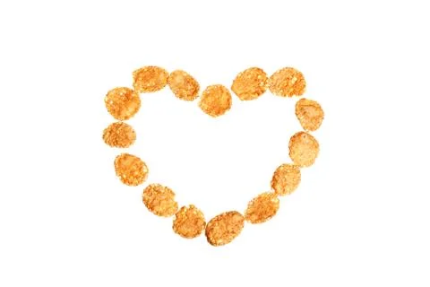 Image of heart shape made of corn flakes against white background Stock Photos
