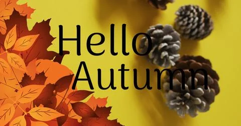 Image of hello autumn text over pine cones and autumn leaves on yellow Stock Photos
