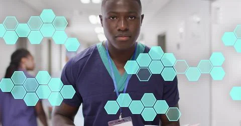 Image of hexagonal structures processing data over smiling african american male Stock Photos