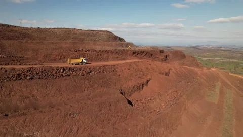 This image highlights the active mining operation within a red earth surface Stock Footage 314847954