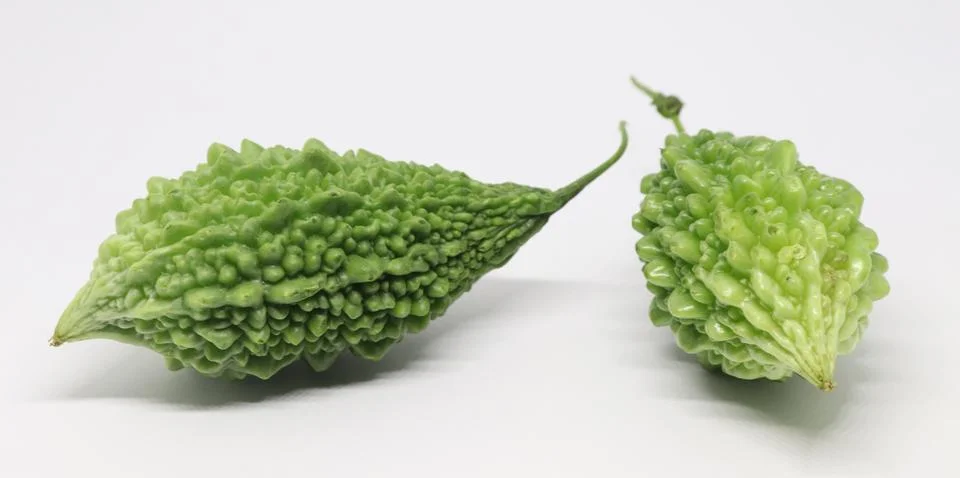 This image highlights two fresh, bumpy textured green bitter melons showcased Foto stock