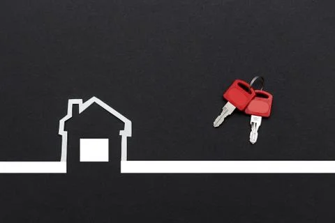 An image of a house with keys on dark background Stock Photos