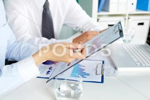 Image of human hands during discussion of business documents at meeting Stock Photos