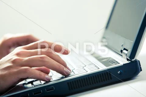 Image of human hands typing on laptop Stock Photos