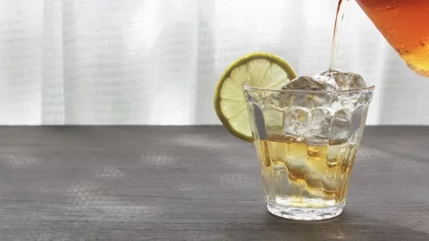Image of iced tea on a table by the window Stock Footage 285281051