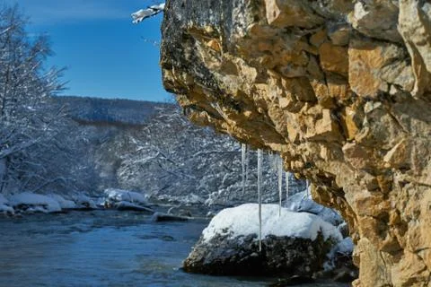 Image of icicles on a rock. Stock Photos