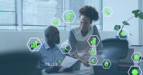 Image of icons and computer language over diverse coworkers discussing reports Stock Photos