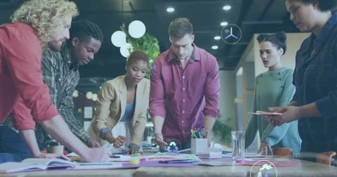 Image of icons and computer language over diverse coworkers creating product Stock Photos