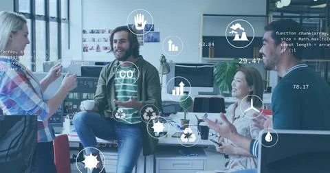 Image of icons and computer language over diverse coworkers discussing during Stock Photos