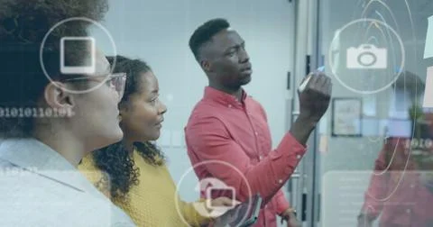 Image of icons and data processing over diverse business people in office Foto stock