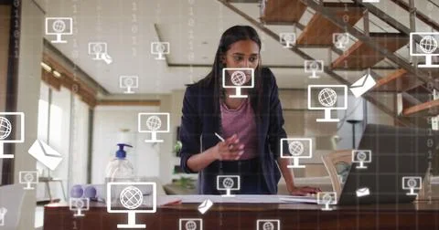 Image of icons and data processing over biracial businesswoman working in office 写真素材