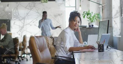 Image of icons and data processing over biracial businesswpman in office Foto stock