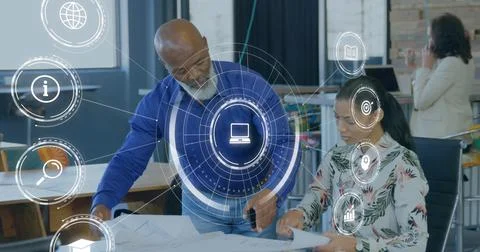 Image of icons and data processing over diverse business people in office Stock Photos