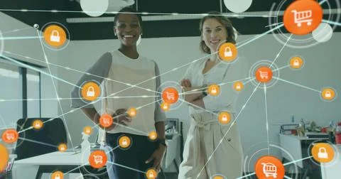Image of icons connected with lines over diverse female coworkers standing in Foto stock
