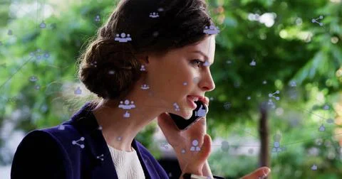 Image of icons connected with lines over caucasian woman talking on smartphone Foto stock