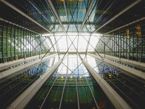 Image from the inside of a building looking up with large reflecting planes.. Stock Photos