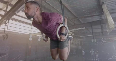 Image of interface processing data over biracial man training on gym rings at Foto stock