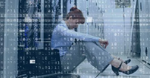 Image of interference and binary coding over caucasian woman in server room 库存照片