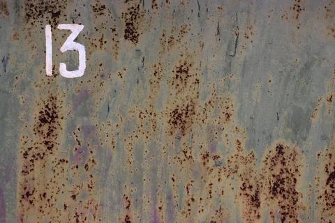 Image of an iron gate with clearly visible traces of rust and the number 13. Stock Photos