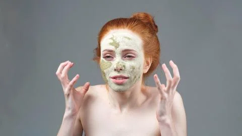 The image of an irritated attractive young model with a mask on her face Stock Photos