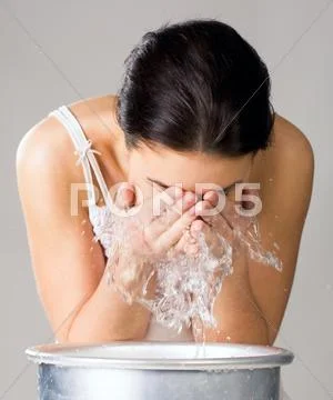 Image of isolated woman washing her face from wash-basin Stock-Fotos