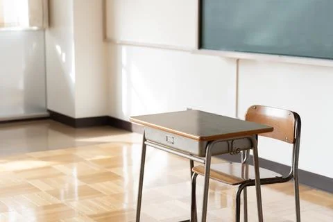 An image of a Japanese elementary school classroom with a blackboard and desk Stock Photos