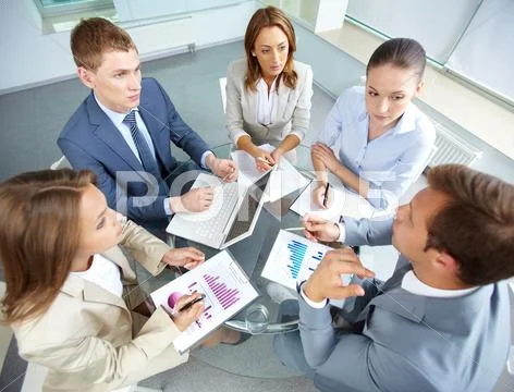 Image of large group of confident partners planning work at meeting Stock Photos