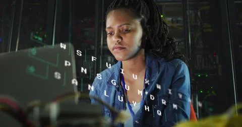 Image of letters changing over biracial woman working on laptop in server room Foto stock