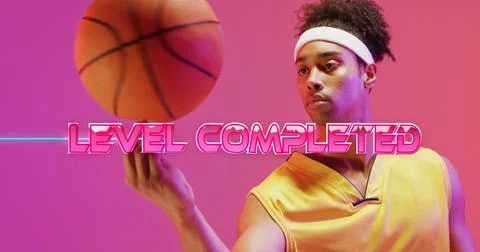 Image of level completed text over neon pattern and biracial basketball player Stockfoto's