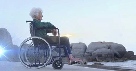 Image of light moving over smiling senior caucasian woman in wheelchair on beach Stock Illustration