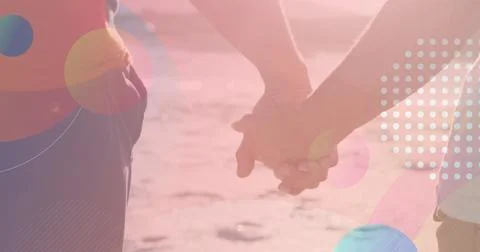 Image of light spots over african american couple walking and holding hands Fotos Stock