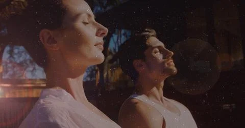 Image of light spots over caucasian couple practicing yoga and meditating Ilustração Stock