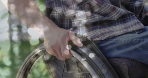 Image of light spots over disabled caucasian man sitting in wheelchair Ilustração Stock