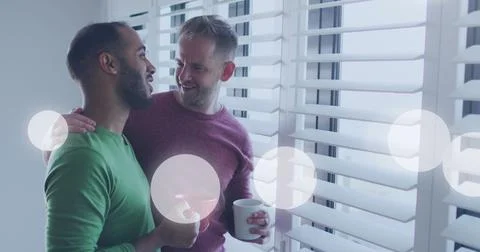 Image of light spots over diverse male couple embracing Ilustração Stock