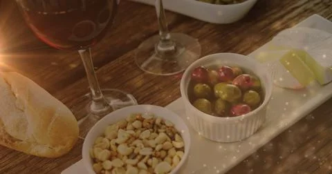 Image of lights over wine and snacks arrangement on wooden table Stock Illustration