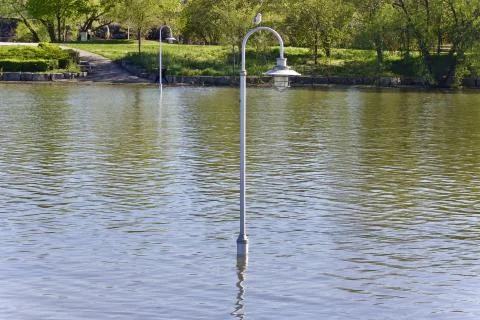 Image of a lights posts in water during flood Stock Photos